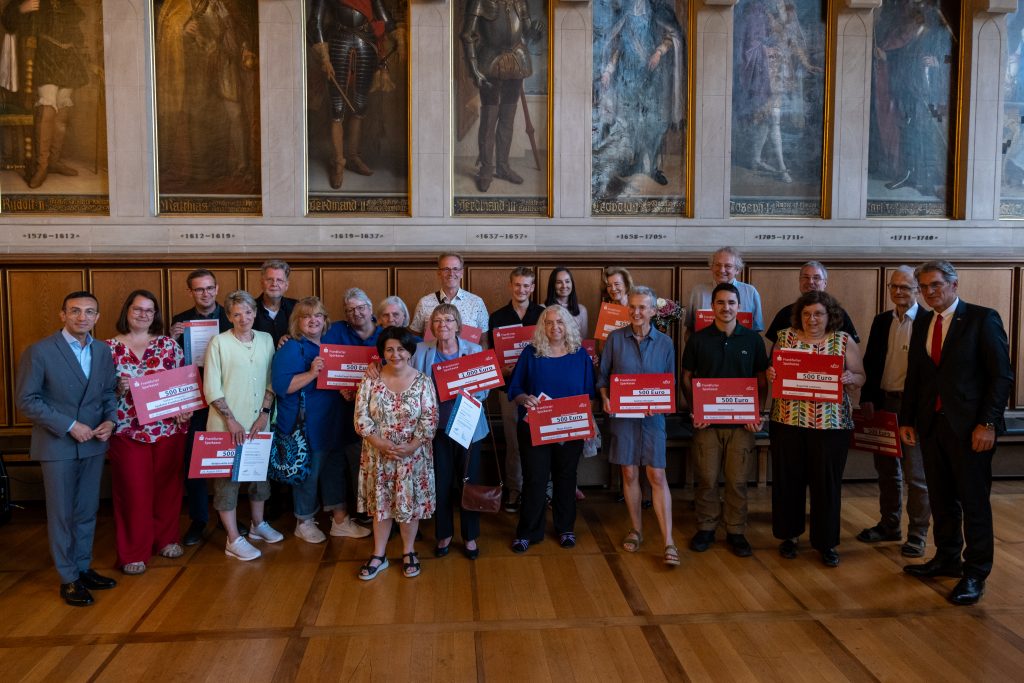 Gruppenfoto der Preisträgerinnen und Preisträger des Frankfurter Bürgerpreises mit dem symbolischen Scheck